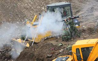 Engineering soldiers fire a missile to blast boulders in a man-made sluice channel in Tangjiashan, quake-hit southwest China's Sichuan Province, June 8, 2008. A total of 4 missiles were fired on Sunday to clear boulders in the sluice channel, which speeded up the drainage of the dangerous Tangjiashan quake lake that began on Saturday morning.(Xinhua Photo)