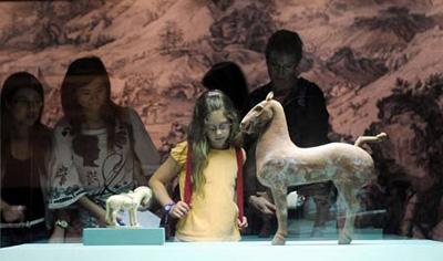 People view exhibits at the "Story of the Horse" exhibition in Hong Kong, south China, on June 27, 2008. About 40 exhibits were displayed in the six-month exhibition for the celebration of Hong Kong's co-hosting of the Equestrian Events of the Beijing 2008 Olympic Games, to be held in August.[Photo: Xinhua]