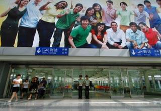 Two armed policemen guard at terminal 3 of the Beijing Capital International Airport in Beijing, China, July 20, 2008. (Xinhua Photo)