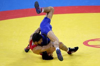 Namig Sevdimov (red) competes against Henry Cejudo.