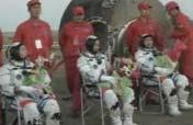 Astronauts exit re-entry capsule 