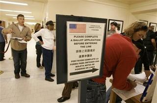 Voters stand in line and fill out forms while registering to vote at City Hall in San Francisco, Monday, Oct. 20, 2008.(AP Photo/Eric Risberg)