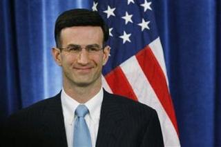 Peter Orszag, the current director of the Congressional Budget Office, smiles as he listens to President-elect Barack Obama speak about choosing Orszag as his choice for director of the Office of Management and Budget (OBM) during a news conference in Chicago, November 25, 2008.(John Gress/Reuters)