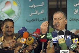 Iraqi parliament member Osama al-Najaifi, of the Iraqi National list, speaks to the press outside the Iraqi parliament in Baghdad's fortified 'Green Zone' Wednesday, Nov. 26 2008. Iraqi lawmakers decided amid a flurry of last-minute negotiations Wednesday to delay a vote on a wide-ranging military pact that would have all US troops withdraw from the country by 2011.(AP Photo / Ali al-Saadi, Pool)