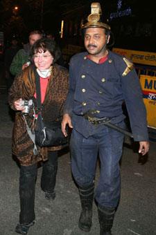 A foreign guest staying at the Taj Hotel reacts after being rescued by a fireman in Mumbai November 27, 2008. At least 101 people have been killed in attacks by gunmen in Mumbai, police said on Thursday.(Xinhua/Reuters Photo)