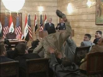 Video frame grab of U.S. President George W. Bush (L) ducking from a shoe during a news conference in Baghdad December 14, 2008.