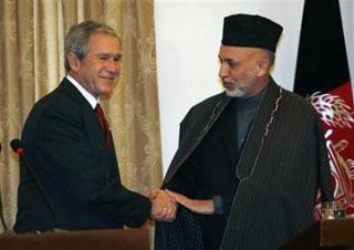 U.S. President George W. Bush (L) and Afghan President Hamid Karzai shake hands at the conclusion of their joint statement to reporters at the Presidential Palace in Afghanistan, December 15, 2008.(Kevin Lamarque/Reuters)