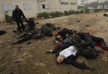 Bodies of Palestinian Hamas policemen are scattered on the ground following an Israeli air strike in Gaza City on December 27, 2008. About 200 Palestinians were killed and hundreds wounded in a series of simultaneous Israeli air strikes in Gaza Strip. (Xinhua/Stringer)