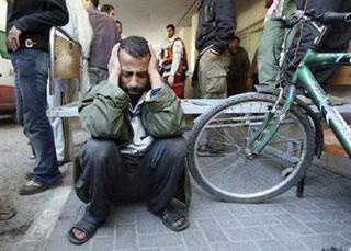 A Palestinian man reacts at the hospital after two of his relatives were killed by an Israeli shell in Gaza January 4, 2009. REUTERS/Suhaib Salem