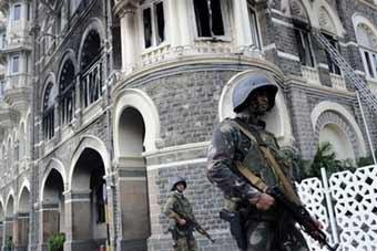 Indian soldiers stand guard outside the Taj Mahal hotel in Mumbai. Indian Prime Minister Manmohan Singh says the Mumbai attacks had the support of "some official agencies" in Pakistan, in his strongest accusation yet against the neighbouring country.(AFP/File/Pedro Ugarte) 