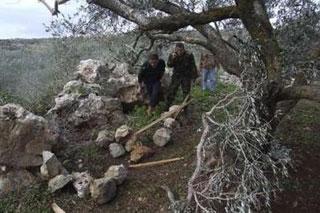 A Lebanese intelligence officer (R) inspects the site where rockets were fired into Israel, in Tayr Harfa village, southern Lebanon January 8, 2009. REUTERS/ Haidar Hawila