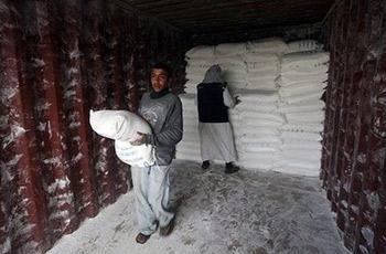 Palestinians receive food aid from the United Nations Relief and Works Agency (UNRWA) at the refugee camp of Rafah in the southern Gaza Strip on the border with Egypt. The main UN agency operating in the Gaza Strip halted its operations on Thursday after an attack on a truck convoy and amid mounting calls for Israel to abide by international humanitarian law.(AFP/Said Khatib)