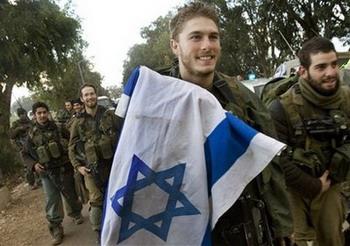 Israeli soldiers, one of them is carrying an Israeli flag, return to Israel from the northern Gaza Strip, Sunday, Jan. 18, 2009. Israel declared a unilateral cease-fire in the Gaza Strip on Sunday meant to end three devastating weeks of war against militants who have traumatized southern Israel for years with rocket attacks. But hours after the truce took hold, militants fired a volley of rockets into Israel, threatening to reignite the violence.(AP Photo/Bernat Armangue)