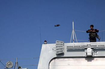 A soldier of Chinese navy special force watches a seabird flying over him on destroyer "Wuhan", flagship of the Chinese naval fleet for an escort mission against piracy off Somali coast, in the Gulf of Aden, on Jan. 18, 2009. The Chinese naval fleet including two destroyers and a supply ship set off on Dec. 26, 2008 for waters off Somalia.(Xinhua/Li Zhen)