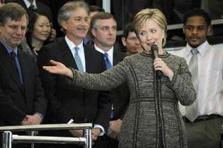 US Secretary of State Hillary Clinton (2nd R) speaks to a lobby filled with employees as she arrives for her first day at the State Department in Washington, January 22, 2009.REUTERS/Jonathan Ernst