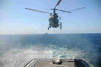 A helicopter unloads supplies onto the deck of Chinese destroyer Wuhan sailing in the Gulf of Aden, on Jan. 31, 2009. The destroyer Wuhan sent a helicopter to fetch supplies from a Chinese merchant ship Xin Fei Zhou on Saturday, which was the first vertical replenishment (VERTREP) done by the Chinese naval fleet since it began its escort mission against pirates on Jan. 6, 2009. (Xinhua Photo)