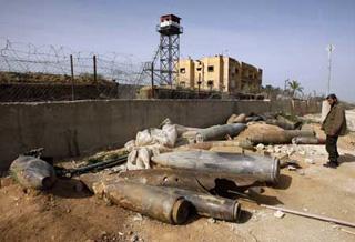 A member of Hamas security forces looks at the remains of spent ammunition and unexploded bombs, fired by Israeli warplanes during Israel's 22-day offensive, in Rafah in the southern Gaza Strip January 26, 2009.(Xinhua/Reuters Photo)