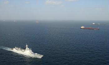 "Haikou" vessel of Chinese navy (front) escorts merchant vessels in the Gulf of Aden, on Feb. 17, 2009. The Chinese naval fleet completed its 21th batch of escort missions against pirates on Wednesday.(Xinhua/Zhu Hongliang)