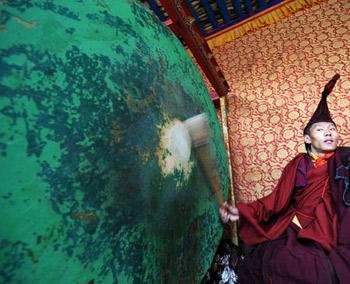 A monk strikes a drum during the Lamaist devil dance ceremony at Tsurpu Monastery, about 70 kilometers of Lhasa, capital of southwest China's Tibet Autonomous Region, Feb. 23, 2009. (Xinhua/Chogo)