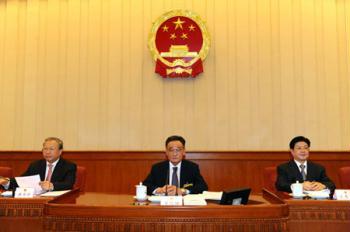 Wu Bangguo (C), chairman of the Standing Committee of the National People's Congress (NPC), presides over the seventh meeting of the 11th NPC Standing Committee in Beijing, capital of China, Feb. 25, 2009. (Xinhua/Li Tao) 