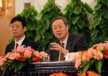 Zhou Xiaochuan (R), governor of the People's Bank of China, answers a question during a press conference on dealing with the global financial crisis and maintaining steady and relatively rapid economic growth held by the Second Session of the 11th National People's Congress (NPC) at the Great Hall of the People in Beijing, capital of China, March 6, 2009. Zhang Ping, minister in charge of the National Development and Reform Commission of China, and Chinese Finance Minister Xie Xuren also attended the press conference. (Xinhua/Rao Aimin)