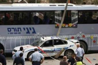 Israeli police officers stand near damaged vehicles after a bulldozer slammed into them in Jerusalem March 5, 2009. The driver of the bulldozer crushed a police car and attacked other vehicles on a busy Jerusalem road on Thursday before police and a taxi driver shot him dead, police and hospital officials said.REUTERS/Darren Whiteside (JERUSALEM)