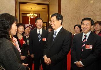 Chinese President Hu Jintao (front, 2nd R) talks to female deputies during the panel discussion of deputies to the Second Session of the 11th National People's Congress (NPC) from south China’s Guangdong Province as International Women's Day is coming, in Beijing, capital of China, March 7, 2009. (Xinhua/Lan Hongguang)