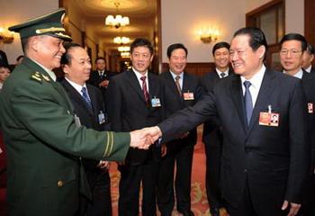 Zhou Yongkang (front R), member of the Standing Committee of the Political Bureau of the Communist Party of China (CPC) Central Committee, attends the panel discussion of deputies to the Second Session of the 11th National People's Congress (NPC) from Tianjin Municipality, in Beijing, capital of China, March 7, 2009. (Xinhua/Yang Zongyou)