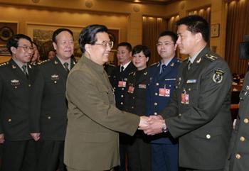 Chinese President Hu Jintao (front L), who is also chairman of the Central Military Commission, shakes hands with a deputy of the Chinese People's Liberation Army (PLA) to the Second Session of the 11th National People's Congress (NPC), in Beijing, capital of China, March 11, 2009. Hu Jintao attended the plenary meeting of the PLA delegation on Wednesday. (Xinhua/Wang Jianmin) 