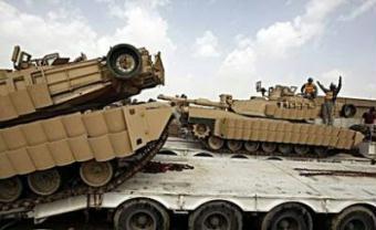 US soldiers load their tanks on tank-carriers at Al-Rustumiyah military base, southeast of Baghdad. A suicide bomber on Tuesday killed 33 people, including tribal chiefs, soldiers and two journalists, in the second major attack around Baghdad in two days, officials said.(AFP/Ahmad al-Rubaye)