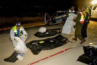 Israeli police gather next to the bodies of two police officers at the scene of a shooting attack outside the settlement of Massua, in the Jordan Valley, late Sunday, March 15, 2009.(AP Photo/Sebastian Scheiner