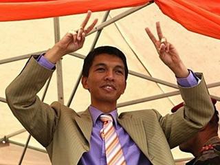 Madagascan opposition leader Andry Rajoelina greets the crowd at a rally in Antananarivo.(AFP/Alexander Joe