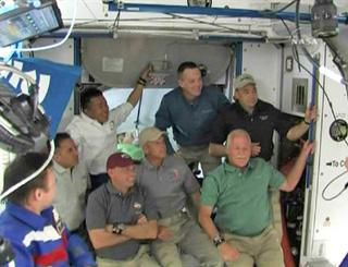 International Space Station flight engineer Yury Lonchakov (L) is seen with members of the Space Shuttle Discovery crew during hatch opening ceremonies aboard the station in this image from NASA TV March 17, 2009. The Discovery astronauts are (L-R) Joseph Acaba, Koichi Wakata of the Japan Aerospace Exploration Agency, Pilot Tony Antonelli, Steve Swanson, Richard Arnold, John Phillips and Shuttle Commander Lee Archambault. (Xinhua/Reuters Photo)