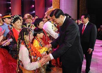 Jia Qinglin, a member of the Standing Committee of the Political Bureau of the Communist Party of China (CPC) Central Committee and chairman of the National Committee of the Chinese People's Political Consultative Conference, and Zhou Yongkang, a member of the Standing Committee of the Political Bureau of the CPC Central Committee and head of the Central Political Science and Law Commission (CPSLC) of the CPC, greet performers at a gala to celebrate the 50th anniversary of the emancipation of Tibetan serfs in Beijing, capital of China, March 28, 2009. (Xinhua/Fan Rujun)