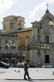 A soldier seen outside the damaged Anime Sante church in L'Aquila, central Italy, Monday, April 6, 2009. A powerful earthquake in mountainous central Italy knocked down whole blocks of buildings early Monday as residents slept, killing 90 people in the country's deadliest quake in nearly three decades, officials said. Tens of thousands were homeless and 1,500 were injured.(AP Photo/Pier Paolo Cito) 