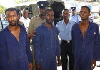 Kenyan police officers escort suspected Somali pirates in the Kenyan coastal town of Mombasa April 8, 2009.REUTERS/Joseph Okanga