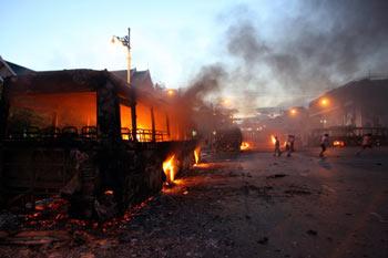  burning bus is seen on a street near the Government House in Bangkok, capital of Thailand, on April 13, 2009. (Xinhua/Zhang Fengguo)