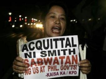 Smith, sentenced to life imprisonment three years ago by a lower court on charges of raping a Filipina, was ordered to be set free, the 71-page ruling said. The placard read 'Acquittal of Smith, conspiracy between U.S. and Philippine governments'.REUTERS/Romeo Ranoco