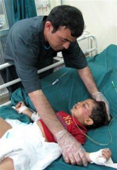 A child injured in a bomb blast gets treatment in a hospital in Baghdad, Iraq, Thursday, April 23, 2009. A suicide bomber blew himself up among a group of Iraqis collecting humanitarian aid Thursday in a mainly Shiite area in Baghdad, killing at least 22 people, the Iraqi military said.(AP Photo/Adil al-Khazali)