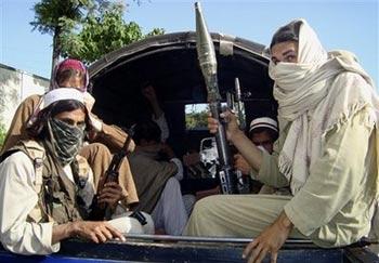 Pakistani Taliban members travel in a van as they leave Buner, northwestern Pakistan on Friday, April 24, 2009. Taliban militants who had seized a district just 60 miles (100 kilometers) from Pakistan's capital began pulling out Friday after the government warned it would use force to evict them. The withdrawal from Buner, if completed, eliminates the most immediate threat to a peace agreement in the neighboring militant-held Swat Valley that the U.S. government worries has created a haven for allies of al-Qaida.(AP Photo/Naveed Ali) 