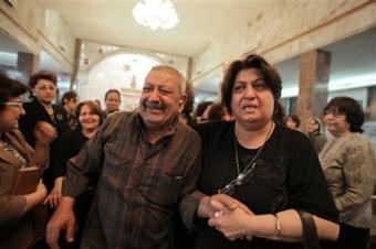 People grieve at a gathering inside a Chaldean Christian church in Kirkuk, 290 kilometers (180 miles) north of Baghdad, Iraq, Monday, April 27, 2009, after unknown attackers killed three Christians a day earlier.(AP Photo/Yahya Ahmed)