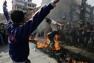 Supporters of Nepal's opposition political parties, who are against Prime Minister Pushpa Kamal Dahal's decision to fire army chief Rookmangud Katawal, set fire on old tires and block roads during a protest in Katmandu, Nepal, Sunday, May 3, 2009.(AP Photo/Gemunu Amarasinghe)