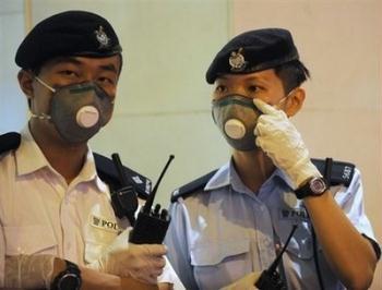 Police wait outside the Metropark Hotel in Hong Kong. Hong Kong chief executive Donald Tsang has confirmed that the Chinese territory has recorded the first confirmed case of swine flu in Asia. Tsang said a Mexican who arrived via Shanghai has tested positive for the virus.