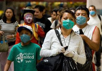 People wear surgical masks in Mexico city, May 3, 2009. Mexican Health Minister Jose Angel Cordova Villalobos late Sunday raised the death toll of the A/H1N1 flu to 22 and the number of infected cases to 568 in the country. (Xinhua/AFP Photo)