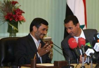 Syria's President Bashar al-Assad (R) and his Iran's counterpart Mahmoud Ahmadinejad speak during a news conference at al-Shaeb presidential palace in Damascus May 5, 2009.REUTERS/Khaled al-Hariri