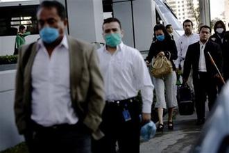 Workers, some wearing protective masks as a precaution against swine flu, arrive for work in Santa Fe neighborhood, Mexico City, Wednesday, May 6, 2009.(AP Photo/Rodrigo Abd)