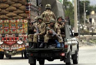 Pakistani soldiers are seen on their way to Pakistan's troubled valley of Swat where government security forces are fighting with Taliban militants, in Mardan near Peshawar, Pakistan on Wednesday, May 6, 2009.(AP Photo/Mohammad Sajjad)