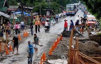 Rescuers and construction workers repair a strom-ravaged bridge along a major highway in the eastern Philippines' city of Sorsogon on May 5.(AFP/File/Charism Sayat)