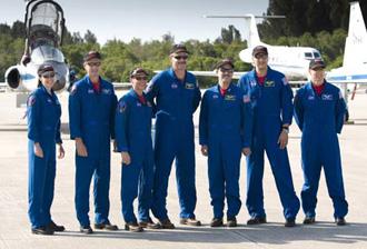 The crew of the space shuttle Atlantis STS-125 (L to R) mission specialist's Megan McArthur, Michael Good, pilot Gregory Johnson, commander Scott Altman, mission specialist's John Grunsfeld, Michael Massimino and Andrew Feustel stand for a group photo after arriving at the shuttle landing facility at Kennedy Space Center in Cape Canaveral, Florida May 8, 2009. (Xinhua/Reuters Photo)