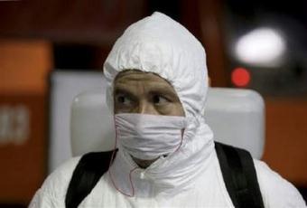 A worker in a protective suit prepares to disinfect the interior of a train carriage to prevent the spread of the Influenza A (H1N1) virus, formerly referred to as swine flu, at the Constitucion de 1917 subway station in Mexico City May 7, 2009.REUTERS/Daniel Aguilar